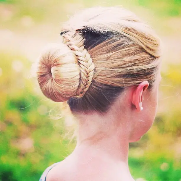 girl-styling-her-hair-as-bun-hairstyle